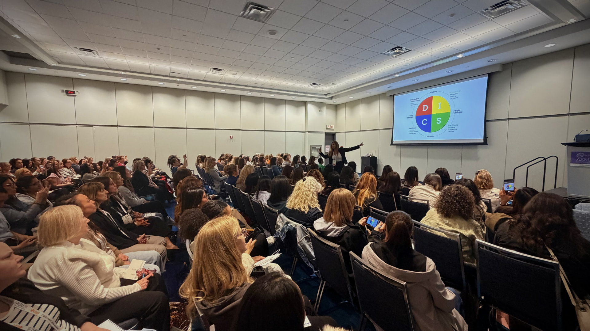 Tala Batarseh presenting to a full audience of dental professionals